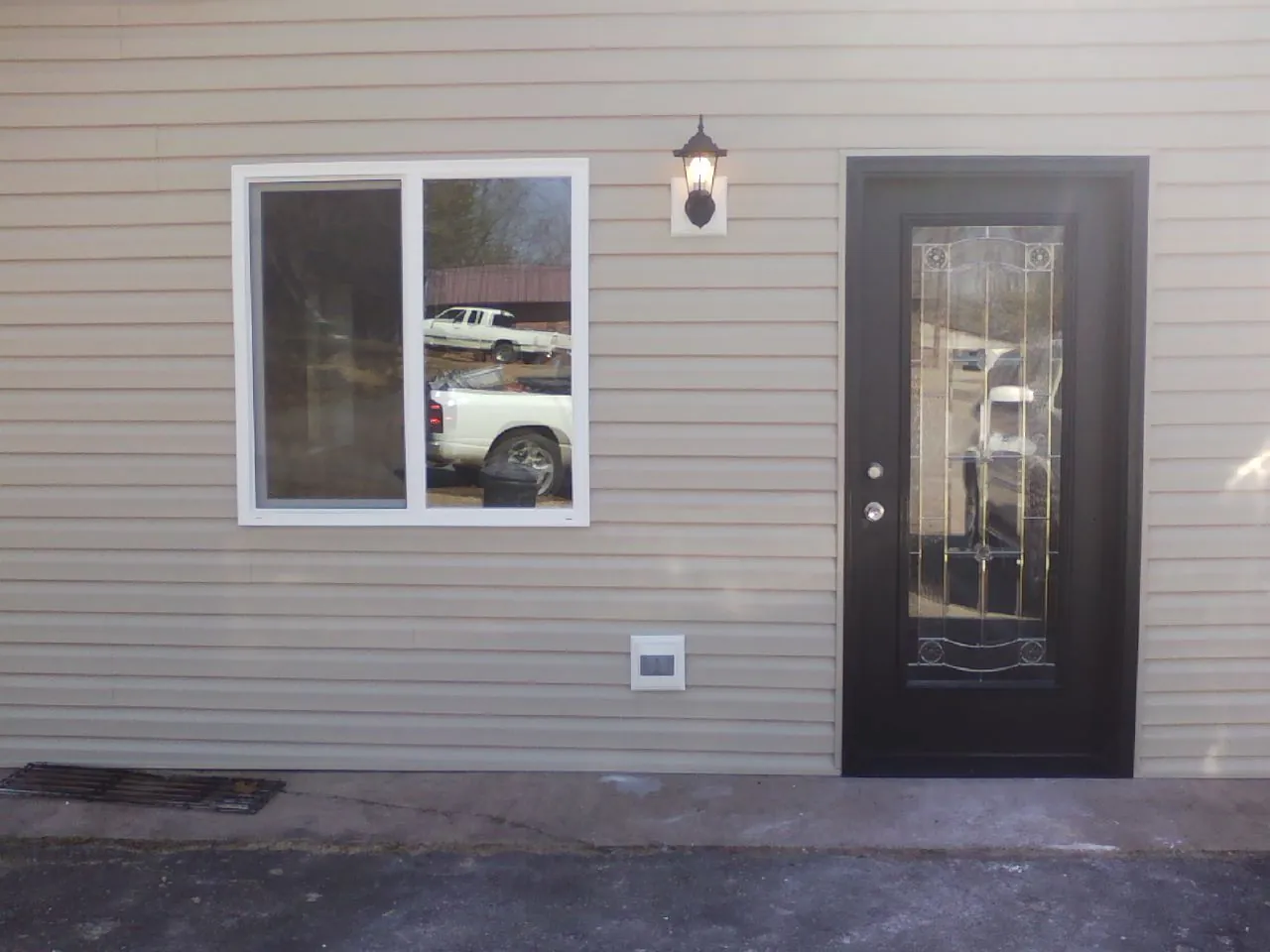 New siding, window and entry door on the side of an addition in Pilot Hill